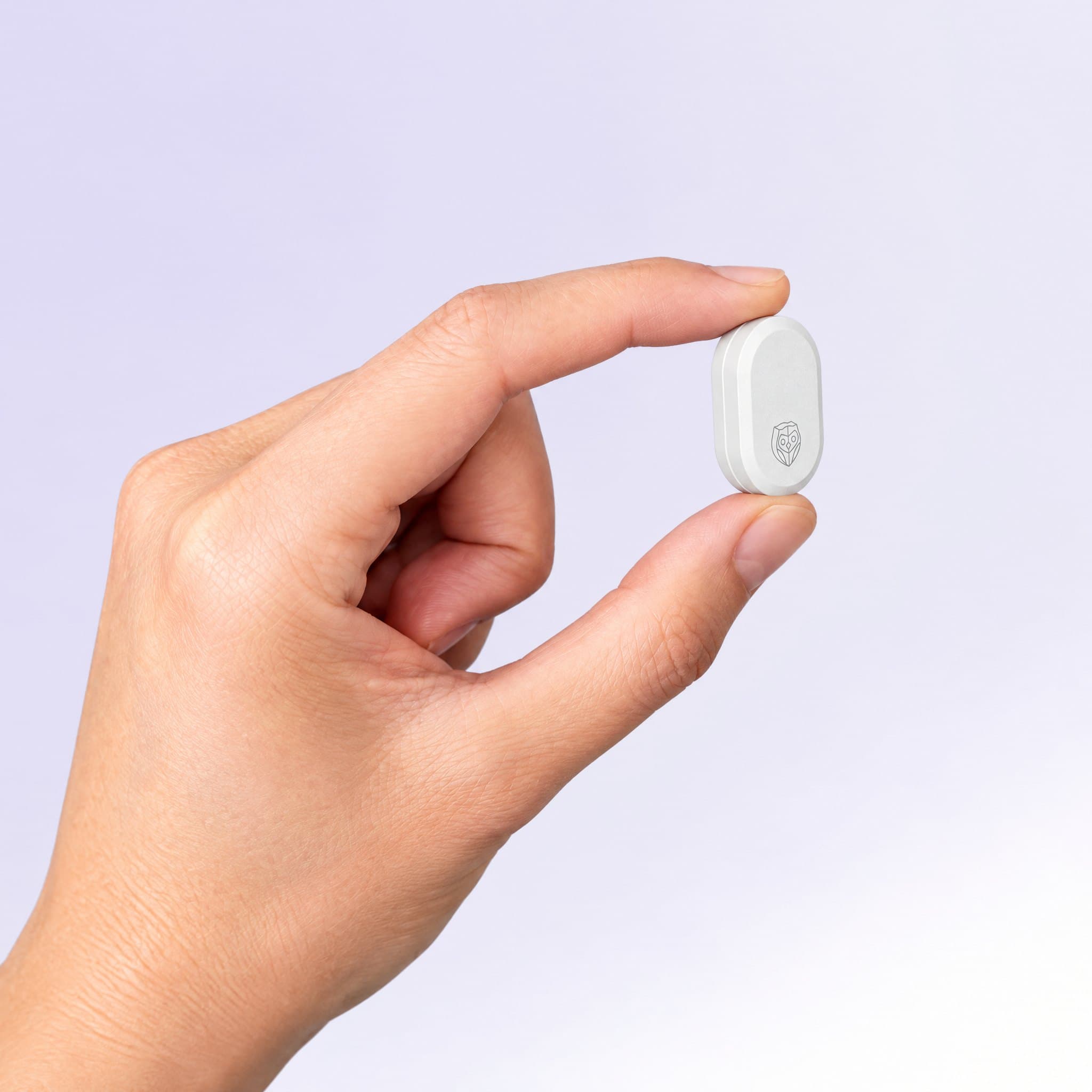 The sensor held between a thumb and fingertip, smaller than the fingertip