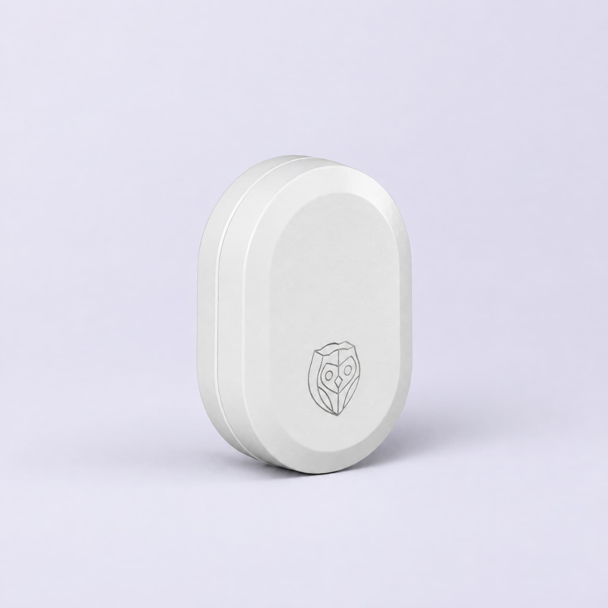 The NightOwl sensor, a small white oval with an engraved owl